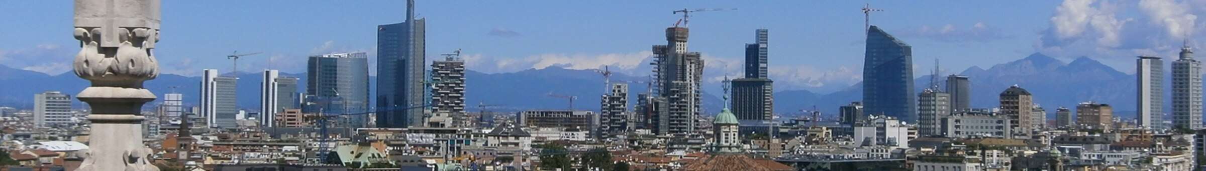 Milan's modern skyline beyond the spires of the Duomo